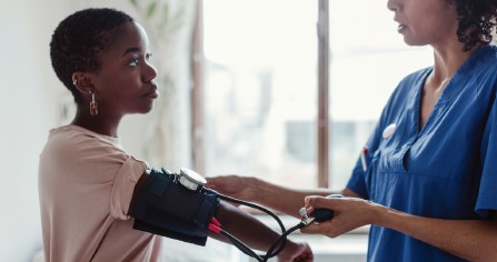 Nurse taking Blood Pressure of patient