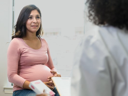 Pregnant woman speaking to Provider