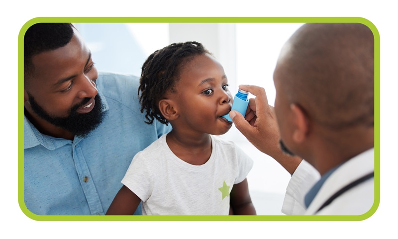 Doctor administering inhaler to child in front of parent.