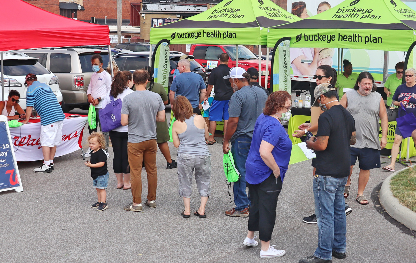 Members form a line at a fruit stand at a local Buckeye Fresh Farmers Market