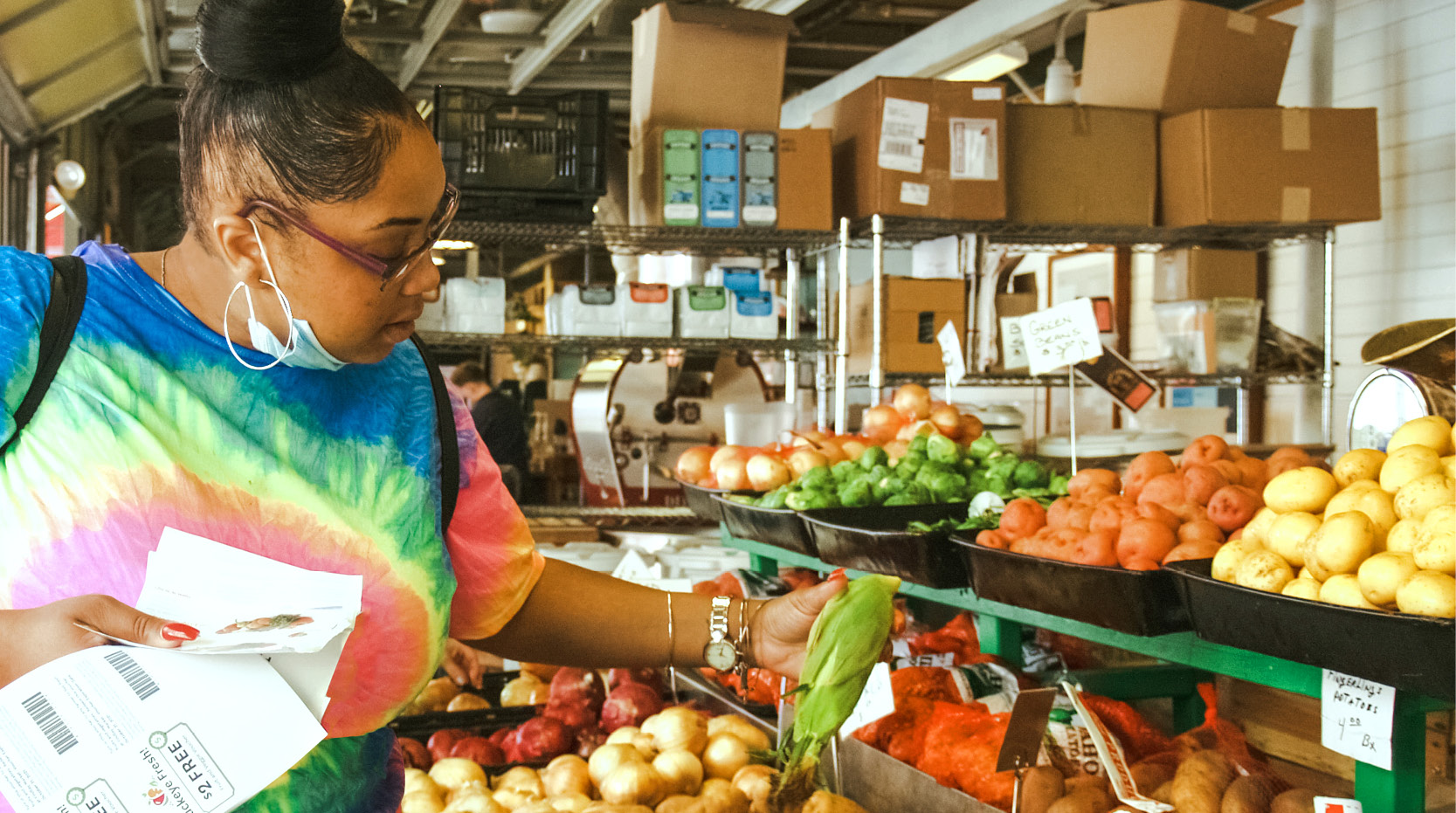 A woman checks out produce at a Buckeye Fresh Farmers market