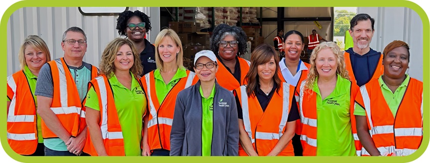 Buckeye staff members in orange vests volunteer at an event