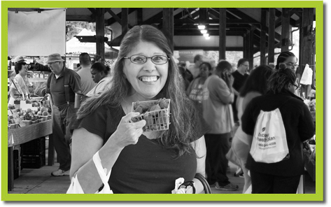 Farmers Market attendee with strawberry. 
