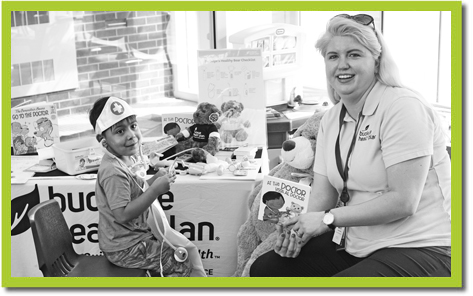 Child receives free book at Read Out and Read Event