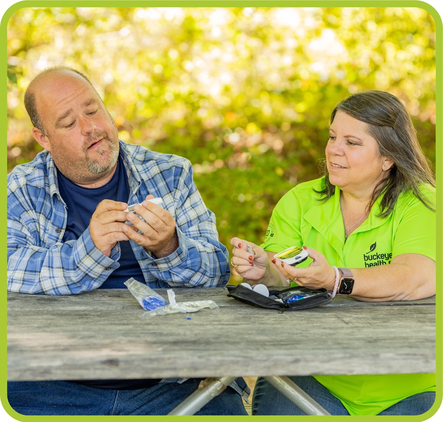 A Buckeye Care manager helps a member check his blood pressure