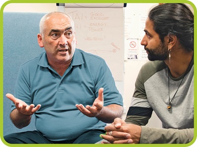 two men face each other and have a conversation