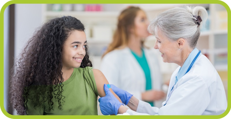 Doctor prepares happy child for her important vaccines.