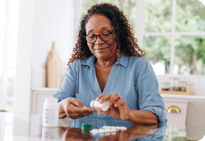 A woman counts her medication pills.