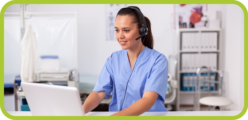 Woman with headset looks at laptop computer