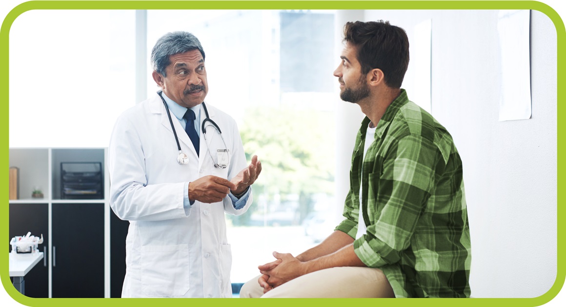 Man sits and talks with doctor. 